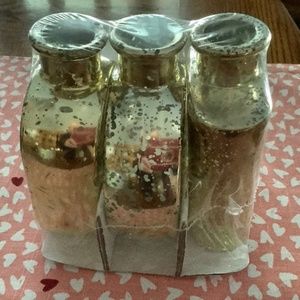 New in pack, 3 , 5 1/2 inch tall gold colored decorative bud vases